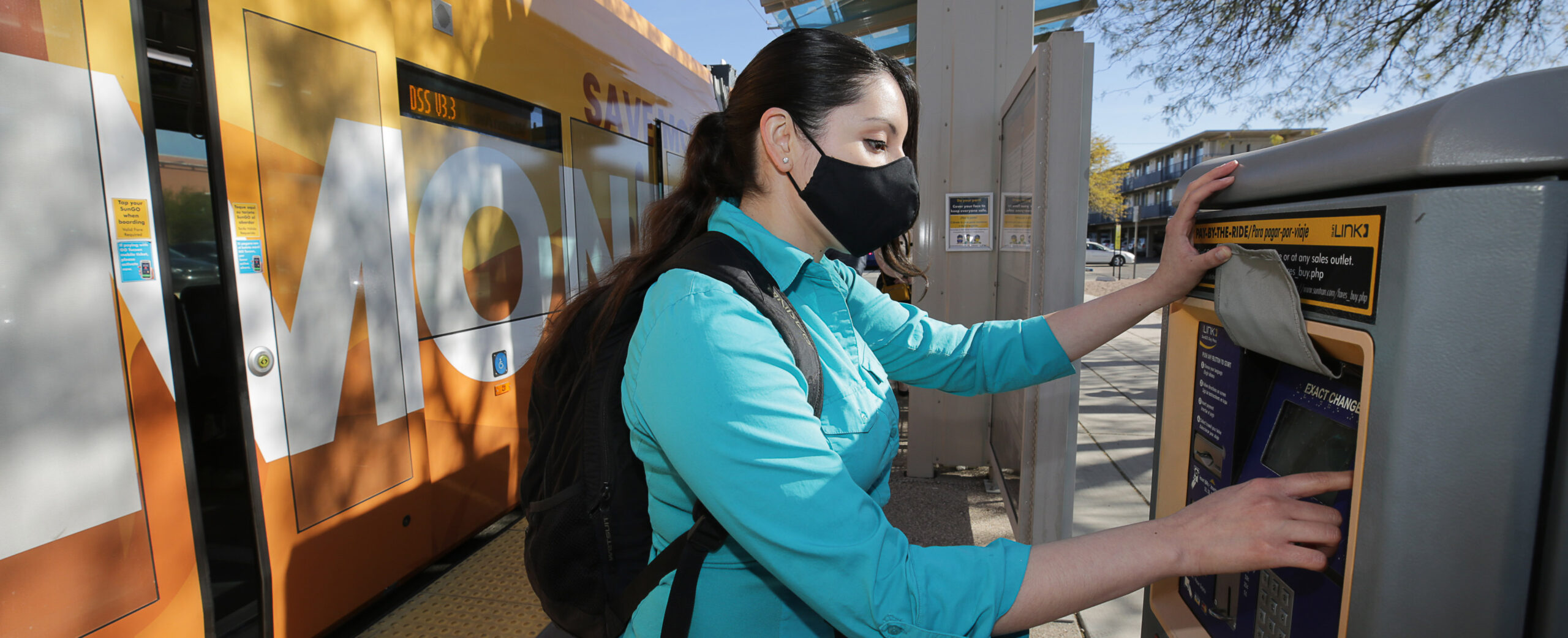 woman buying a pass from a machine