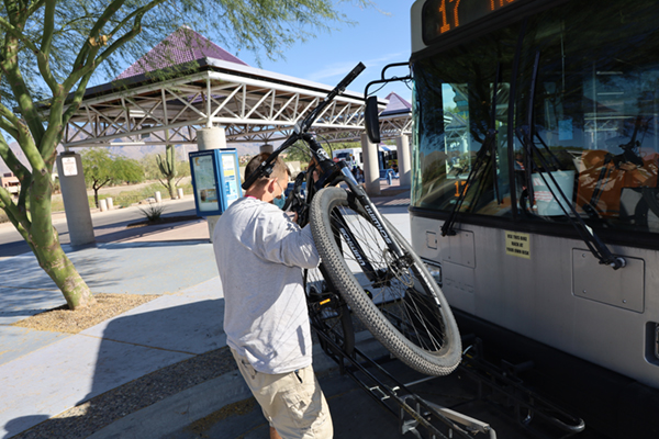 person putting bike on rack