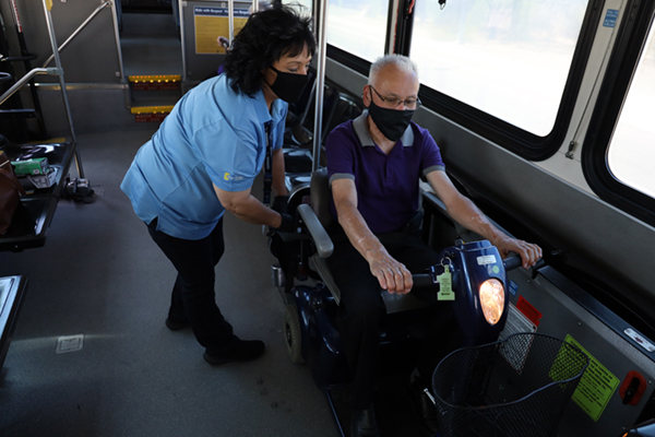 driver securing person in mobility vehicle