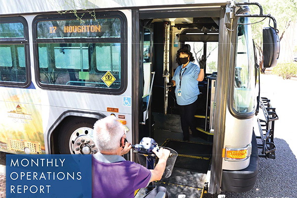 report cover driver wearing mask standing in bus doorway