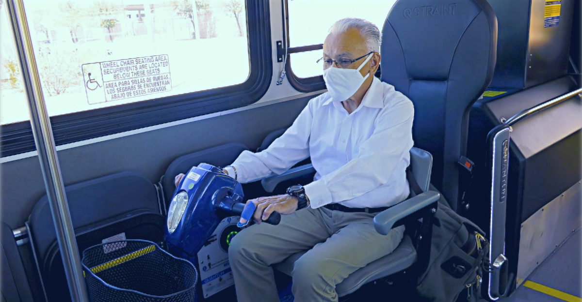 Rider in a power scooter uses Quantum device on a Sun Tran bus