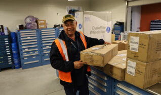 John Baker moves boxes in the parts department.