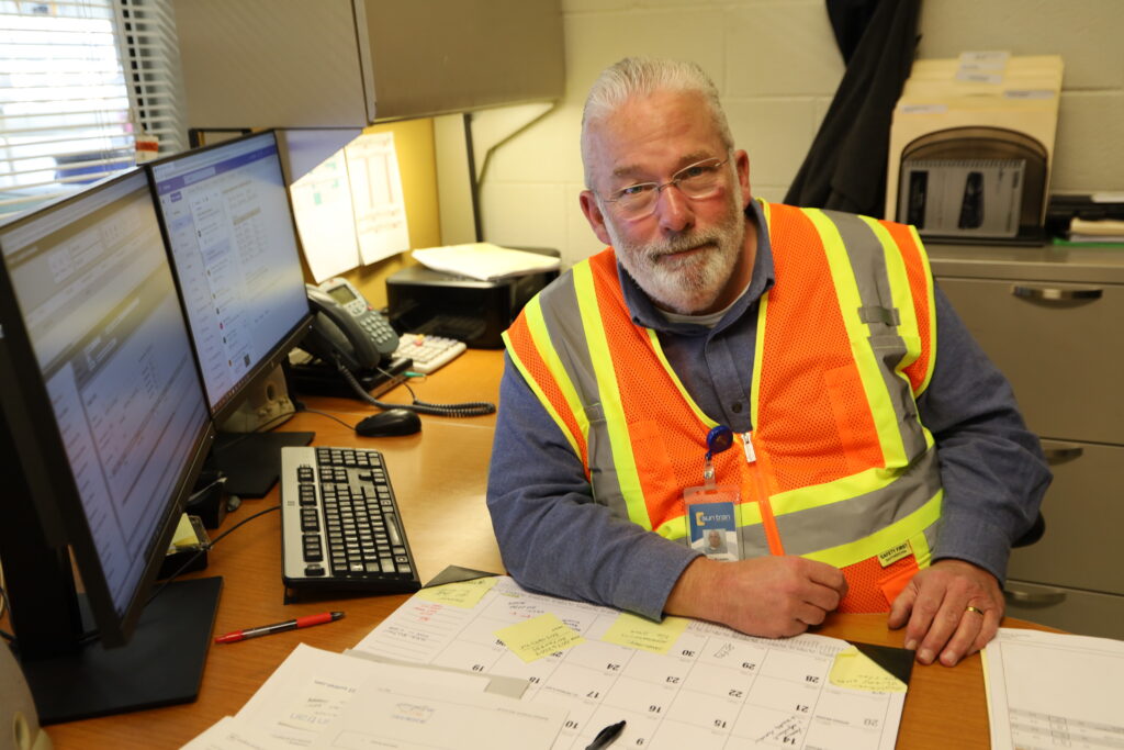 Kevin Motzkin, Sun Tran Parts Manager sits at his desk.