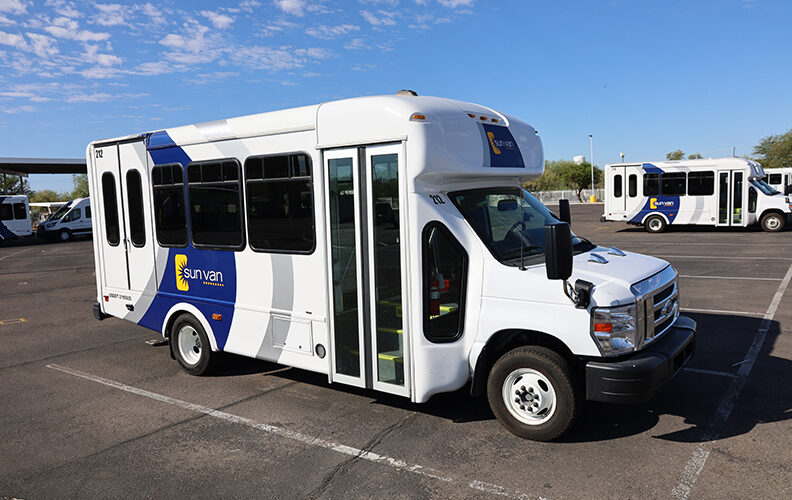 Sun Van Ford vehicle for paratransit users. The vehicle is outside on a bright blue day.