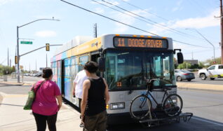 image of route 11 bus at bus stop with passengers boarding