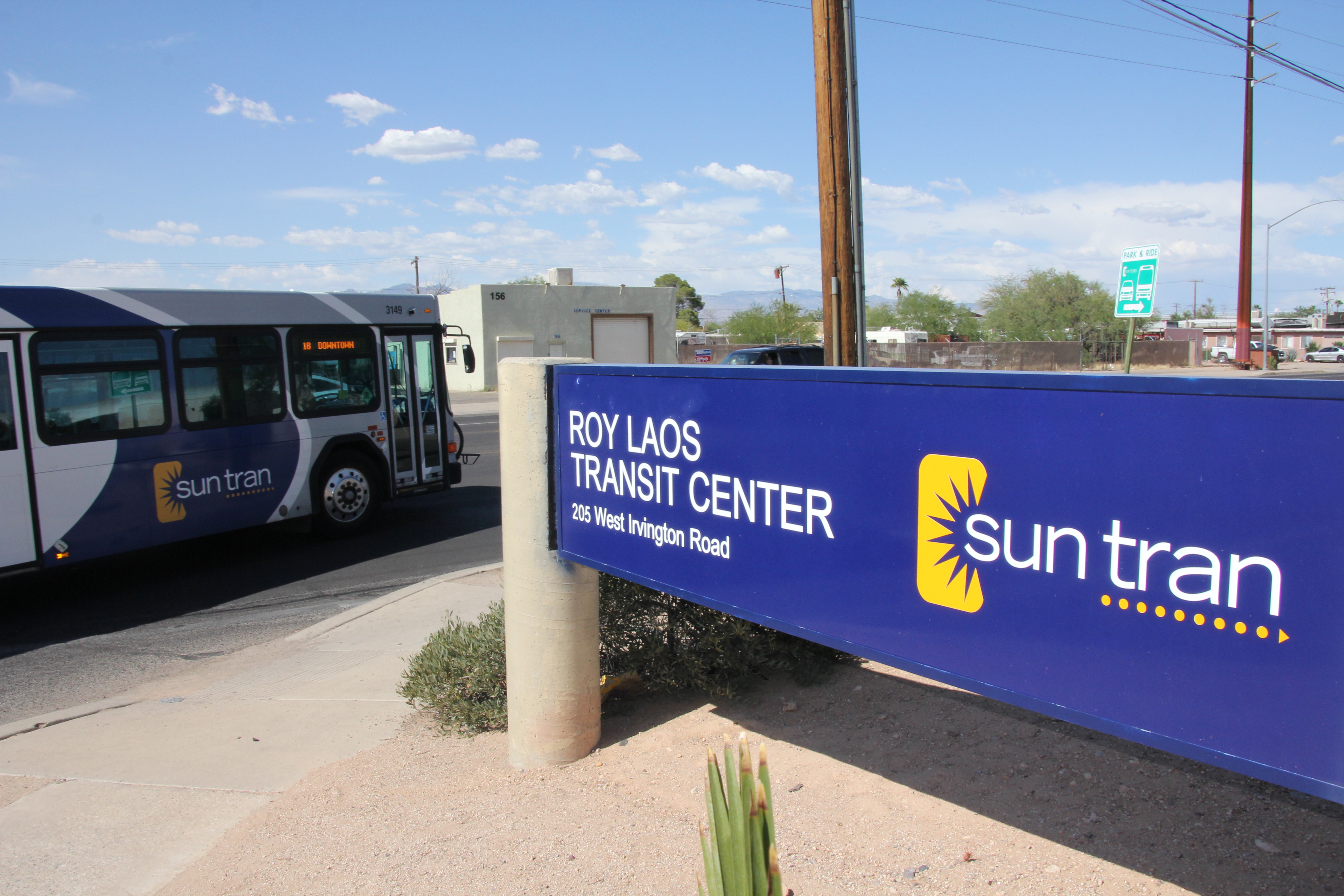 photos of laos transit center sign with a bus leaving the center