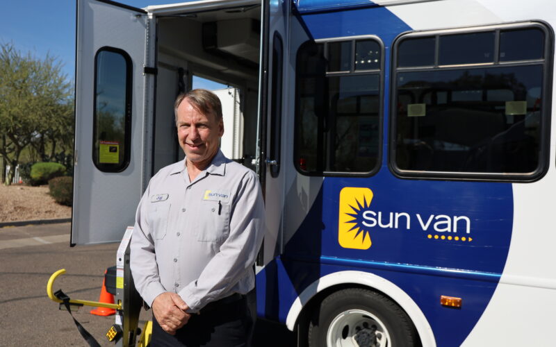 Sun Van Operator in front of Sun Van vehicle
